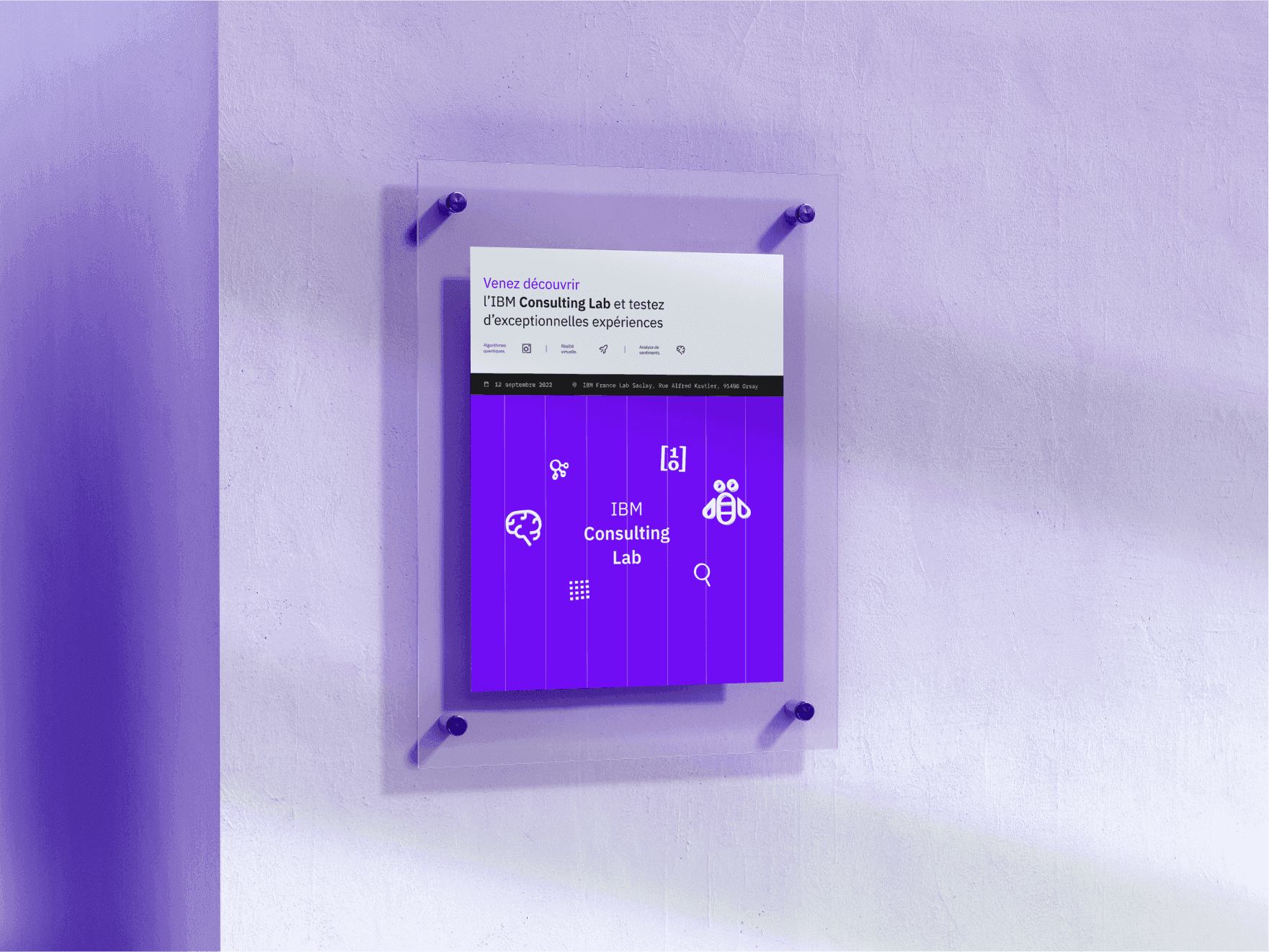 An IBM Consulting Lab poster mounted on acrylic against a wall